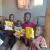 A Christian family in Zimbabwe holding bags of ePap